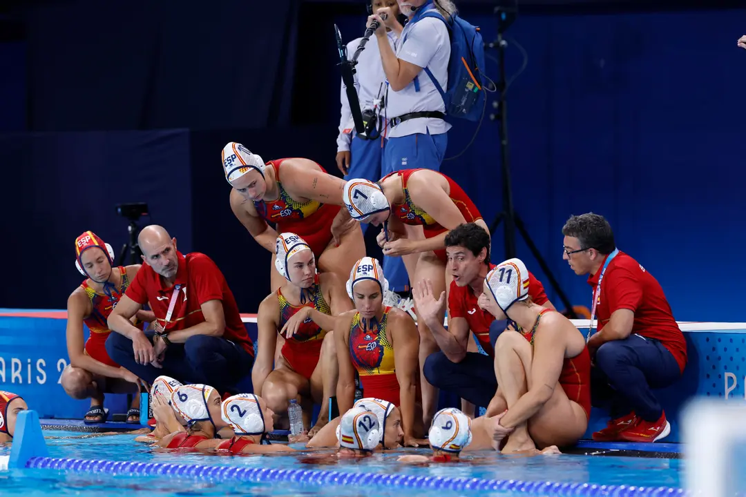 El entrenador espa&ntilde;ol, Miguel &Aacute;ngel Oca (3d), habla con las jugadoras durante el partido de la ronda preliminar del Grupo B de Waterpolo Femenino, entre Francia y Espa&ntilde;a, de los Juegos Ol&iacute;mpicos de Par&iacute;s 2024 este s&aacute;bado en el Centro Acu&aacute;tico de la capital francesa. EFE/ Julio Mu&ntilde;oz