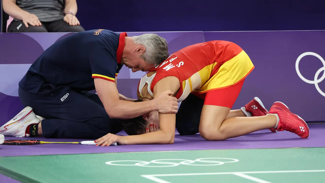 Carolina Mar&iacute;n recibe es consolada por su entrenador Fernando Rivas (i) tras lesionarse en la rodilla derecha durante su partido de semifinales de b&aacute;dminton ante He Bing Jiao, de China. EFE/ Miguel Guti&eacute;rrez